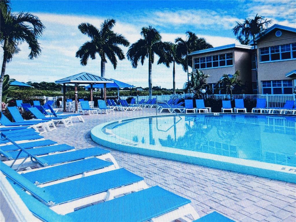 19417 Gulf Boulevard, Unit B209 Indian Rocks Beach, FL 33785 - Photo 21 of 24 a view of a swimming pool with a patio