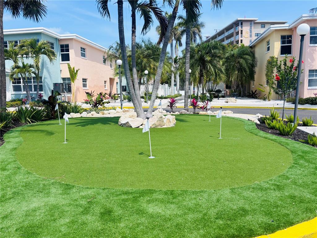19417 Gulf Boulevard, Unit B209 Indian Rocks Beach, FL 33785 - Photo 23 of 24 a view of a swimming pool with a patio and a yard