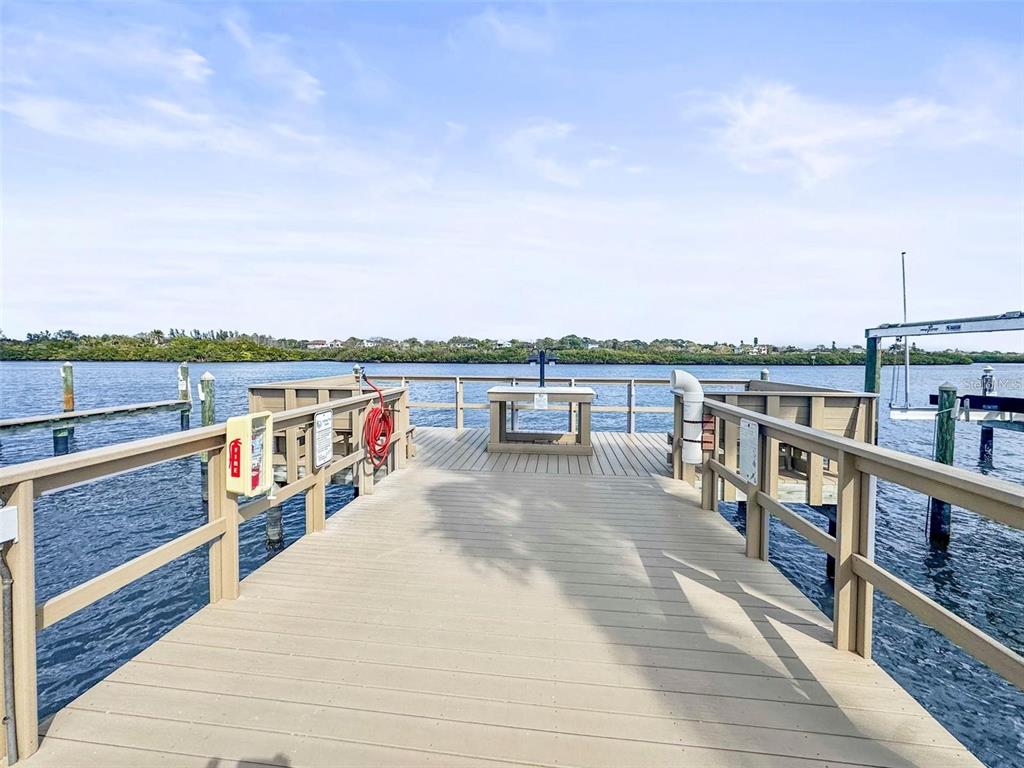 19417 Gulf Boulevard, Unit B209 Indian Rocks Beach, FL 33785 - Photo 24 of 24 a view of roof deck with two chairs and wooden floor
