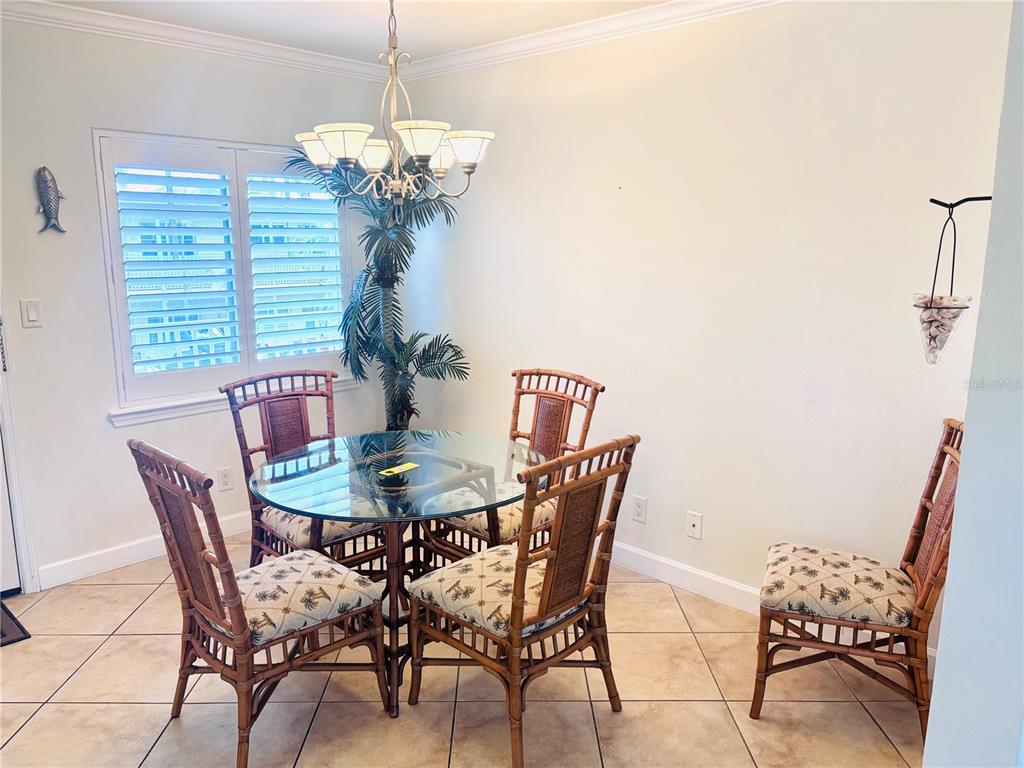19417 Gulf Boulevard, Unit B209 Indian Rocks Beach, FL 33785 - Photo 6 of 24 a dining room with furniture and window