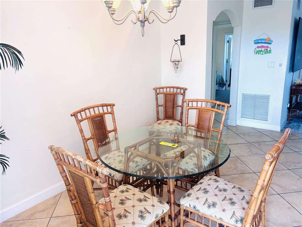 19417 Gulf Boulevard, Unit B209 Indian Rocks Beach, FL 33785 - Photo 7 of 24 a view of a dining room with furniture