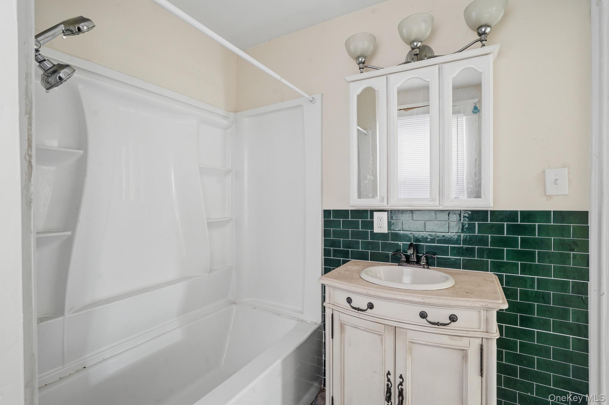 65 North Clinton Street Poughkeepsie, NY 12601 - Photo 19 of 43 a bathroom with a sink a toilet and shower