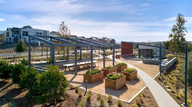 a view of a patio with couches chairs potted plants and water view
