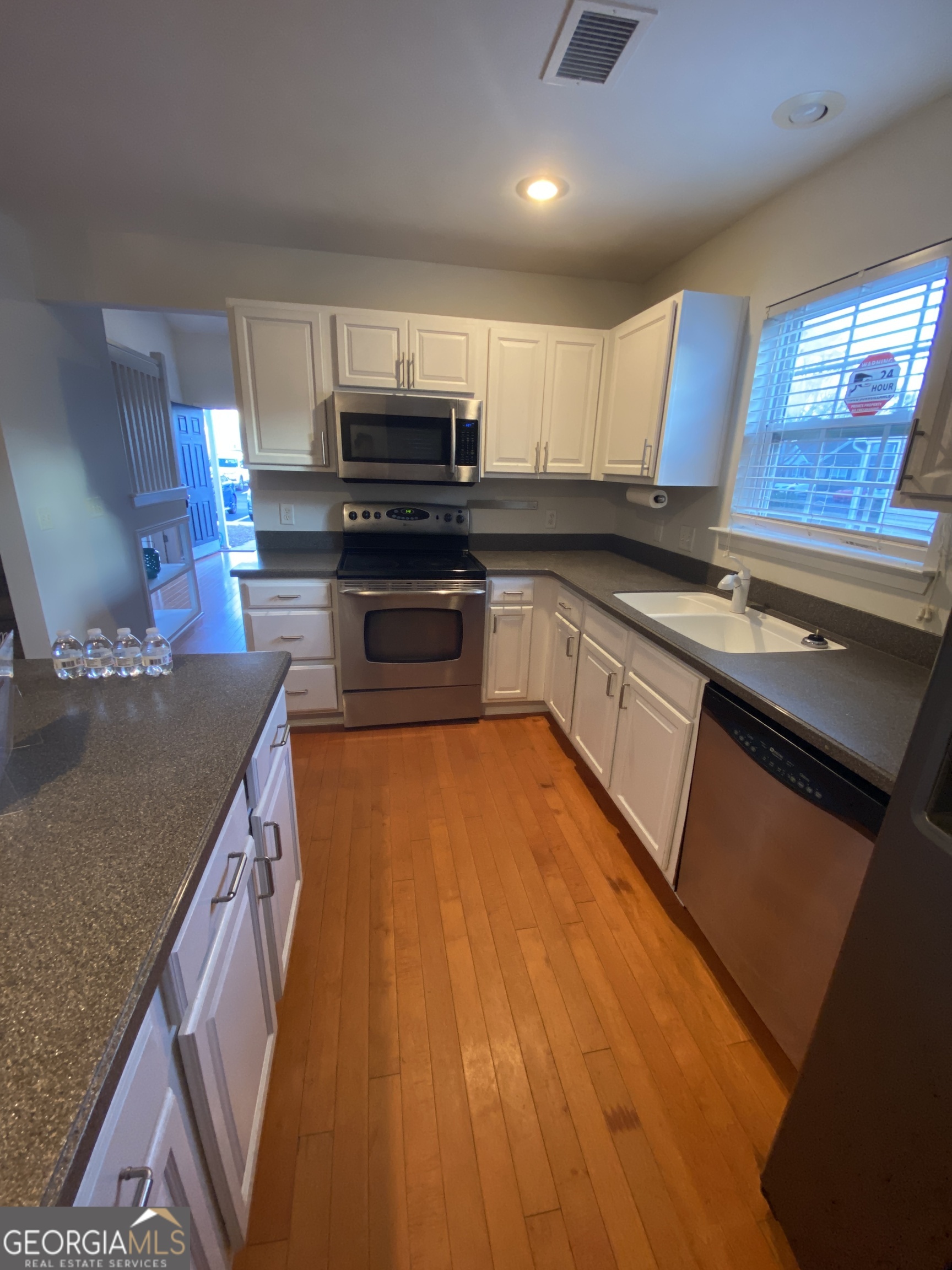 172 Sonata Circle Pooler, GA 31322 - Photo 23 of 48 a kitchen with stainless steel appliances granite countertop a sink a stove top oven a counter space and cabinets