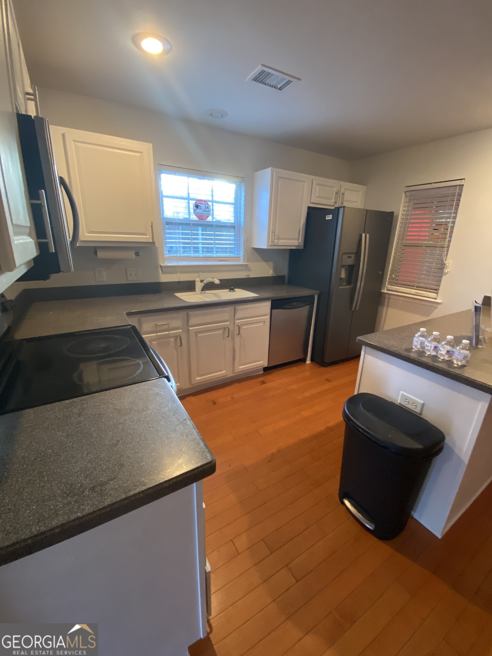 172 Sonata Circle Pooler, GA 31322 - Photo 25 of 48 a kitchen with stainless steel appliances granite countertop a sink and a stove top oven