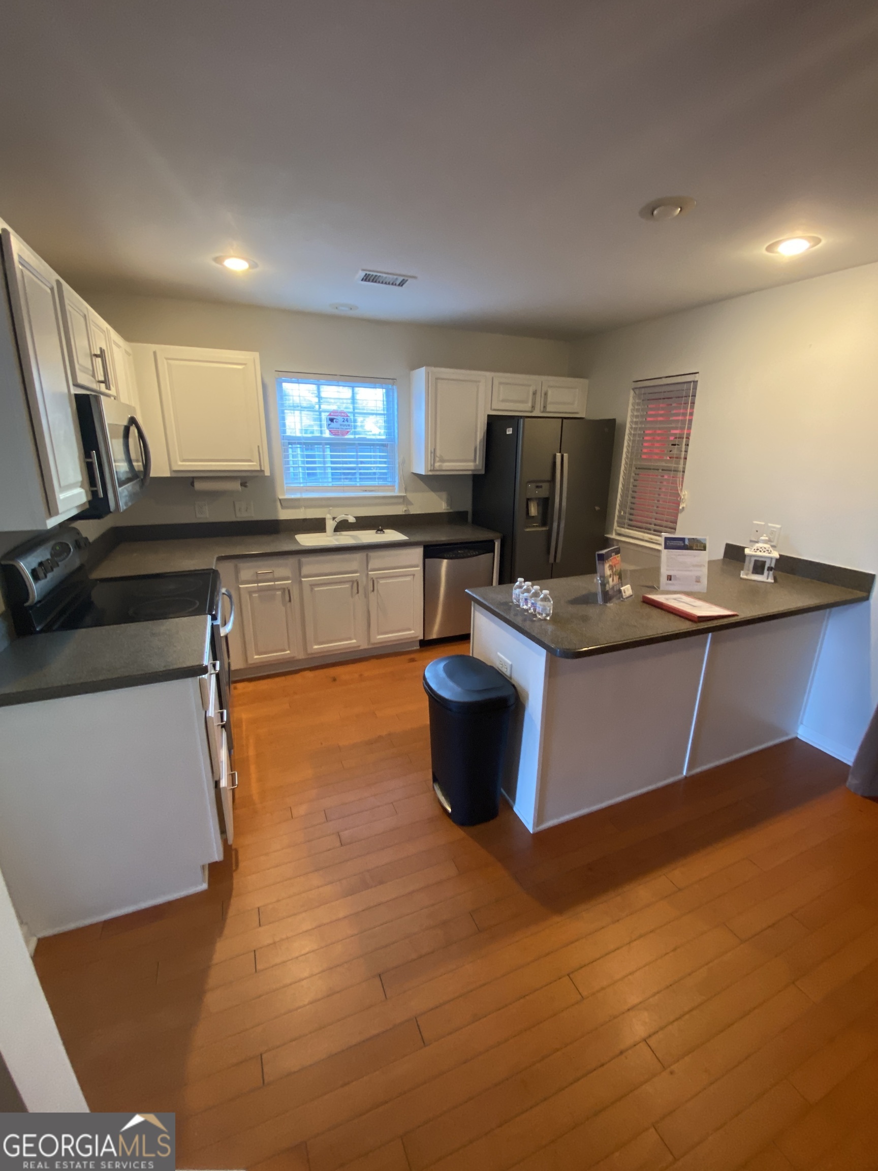 172 Sonata Circle Pooler, GA 31322 - Photo 26 of 48 a kitchen with stainless steel appliances granite countertop a sink counter space and a window