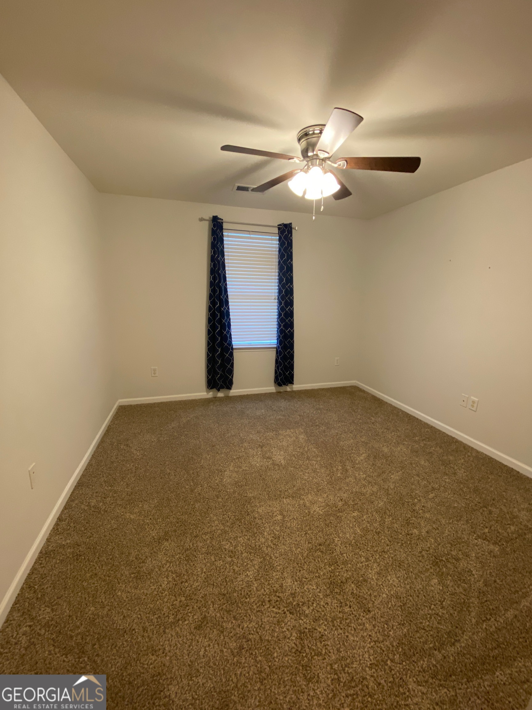 172 Sonata Circle Pooler, GA 31322 - Photo 29 of 48 a view of an empty room with a ceiling fan and a window