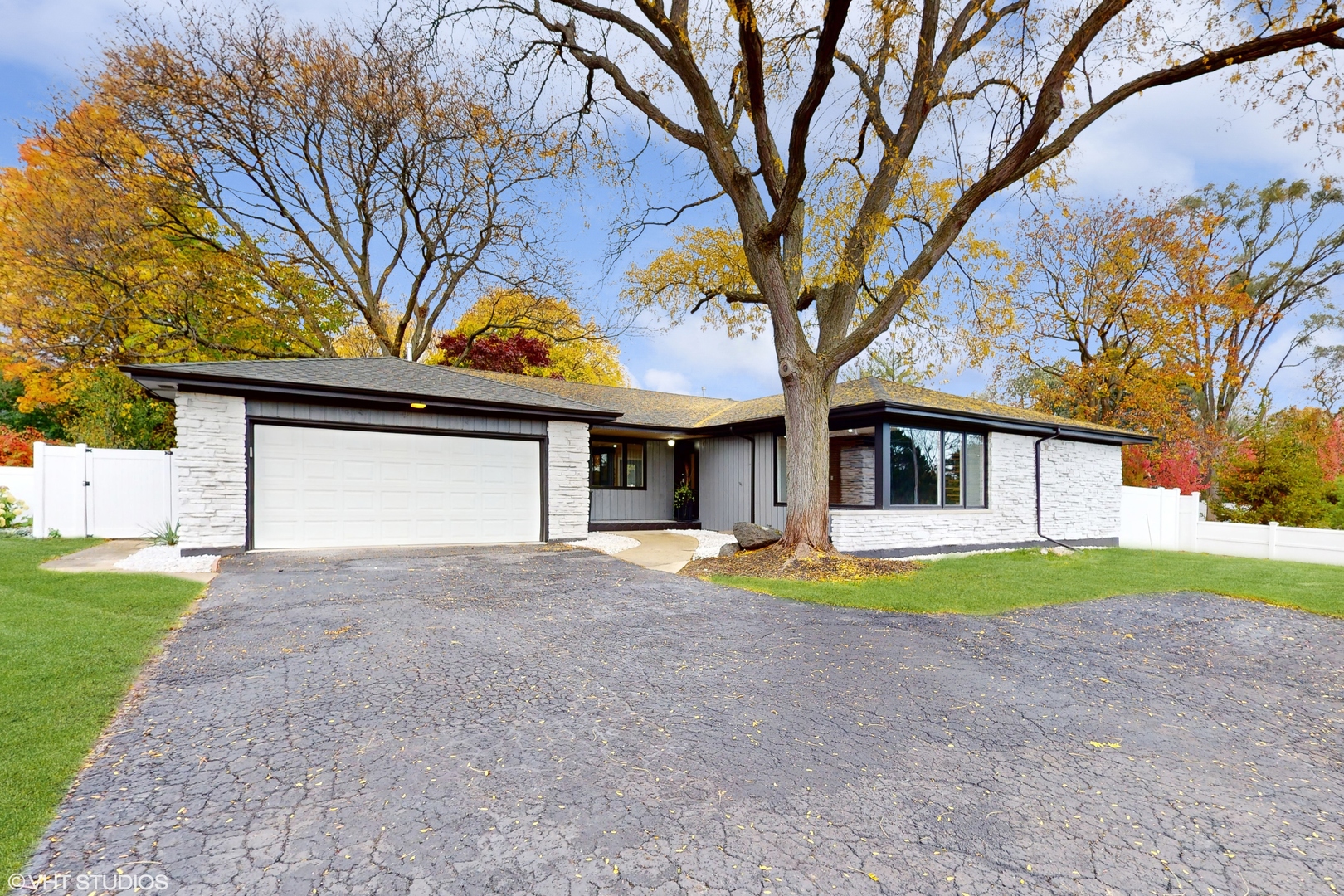2140 Pfingsten Road Northbrook, IL 60062 - Photo 2 of 44 a front view of a house with a yard and garage