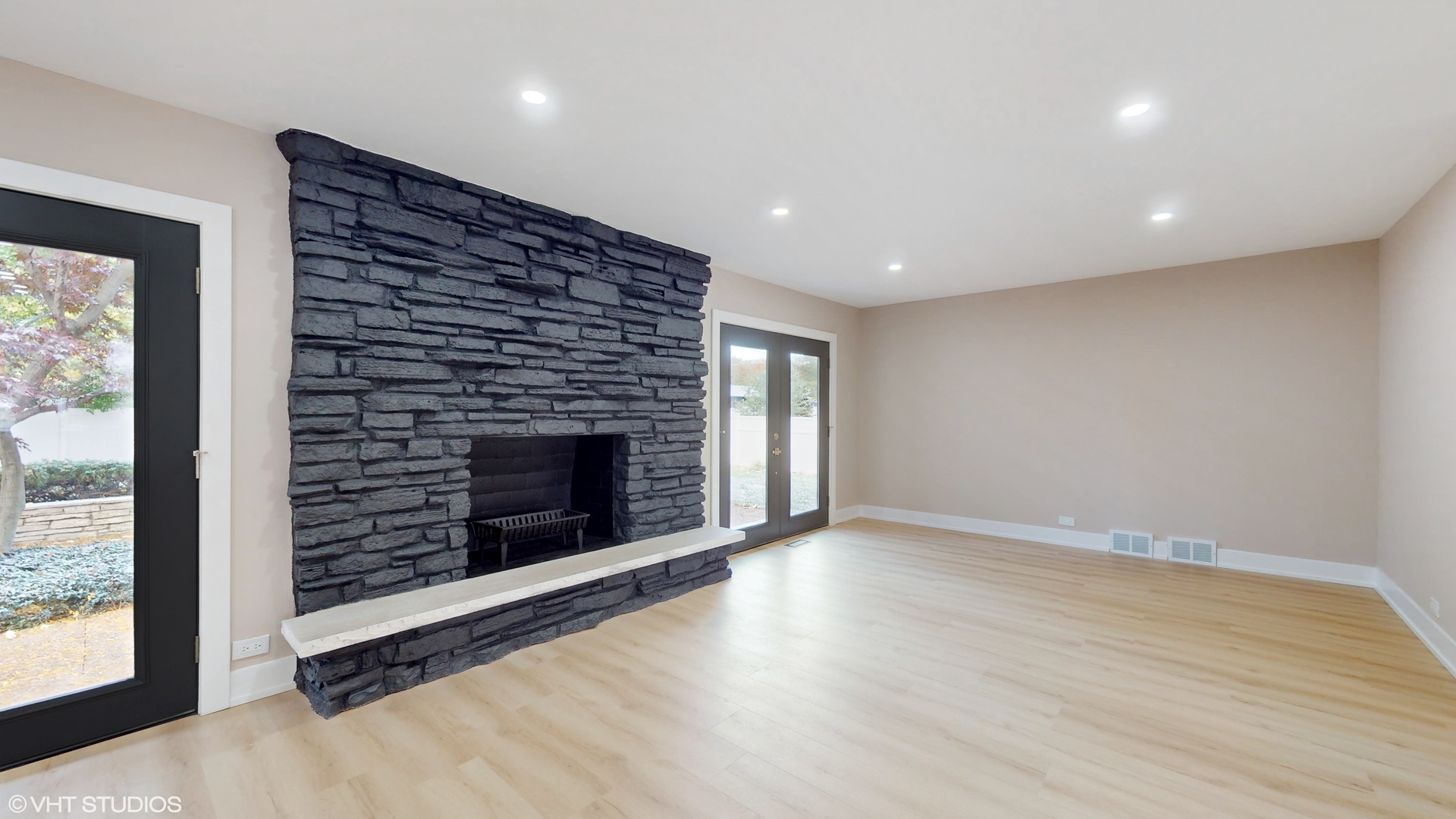 2140 Pfingsten Road Northbrook, IL 60062 - Photo 7 of 44 an empty room with wooden floor fireplace and windows