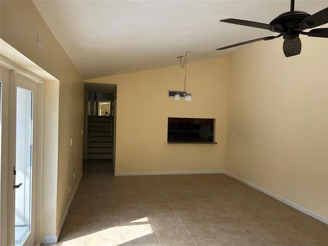 a view of a room with a mirror and a ceiling fan