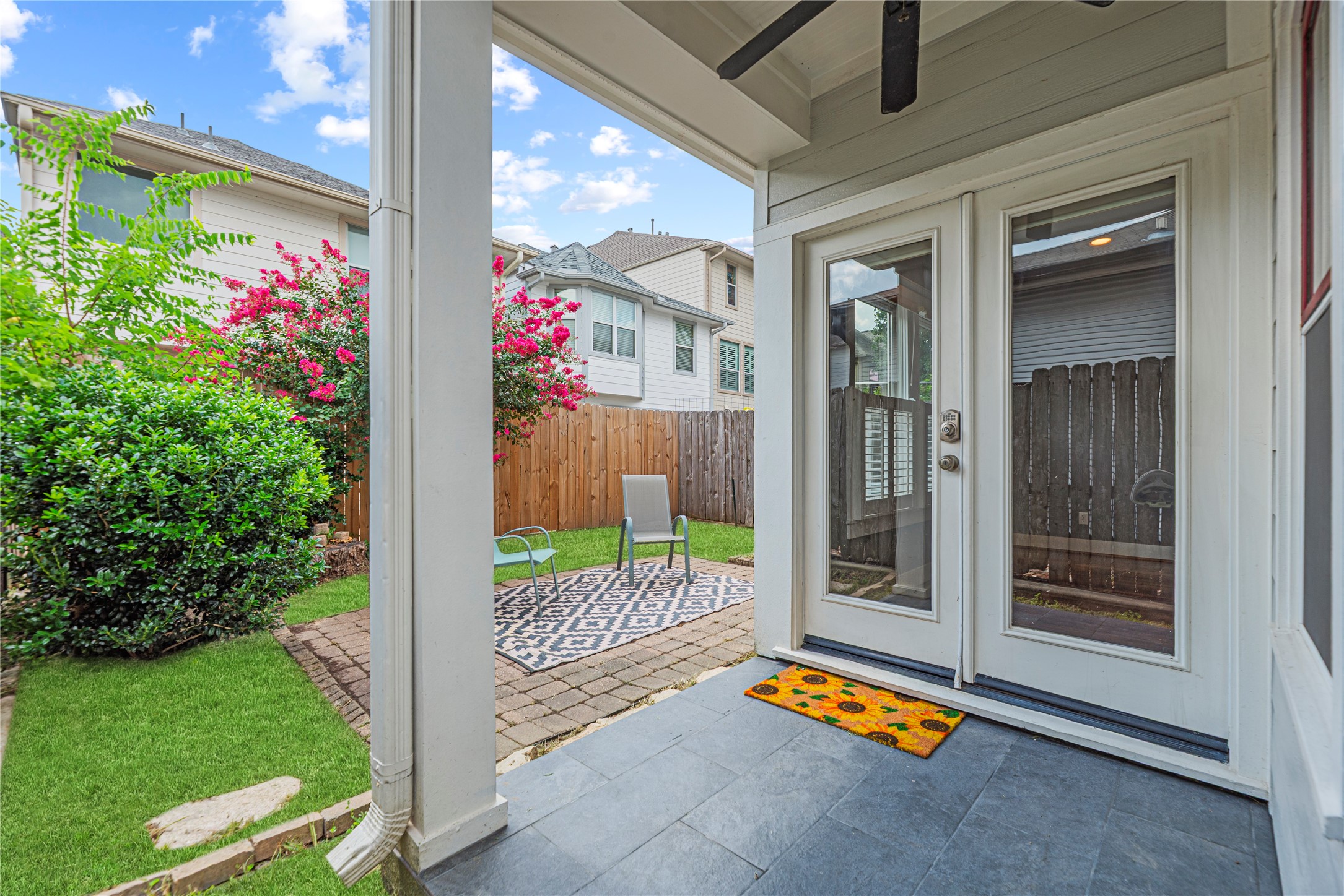 1505 Prince Street Houston, TX 77008 - Photo 28 of 39 Charming backyard features a covered patio with ceiling fan, paved area, and thoughtful landscaping, with plenty of room to play or let the dog roam.