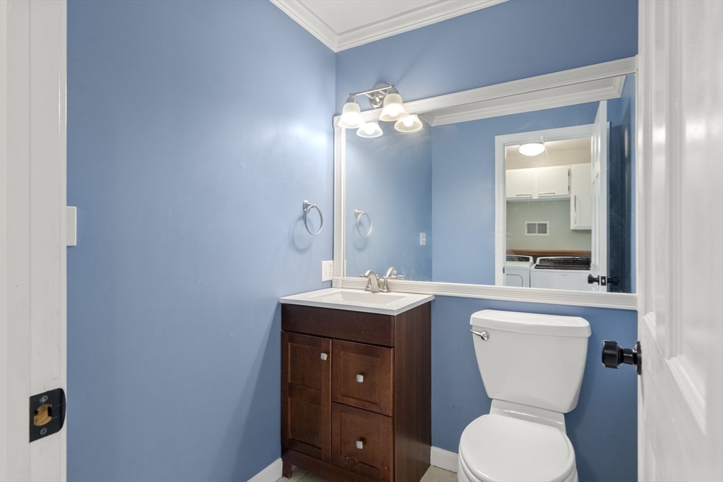 731 R Grove Street Norwell, MA 02061 - Photo 15 of 42 a bathroom with a toilet sink and mirror