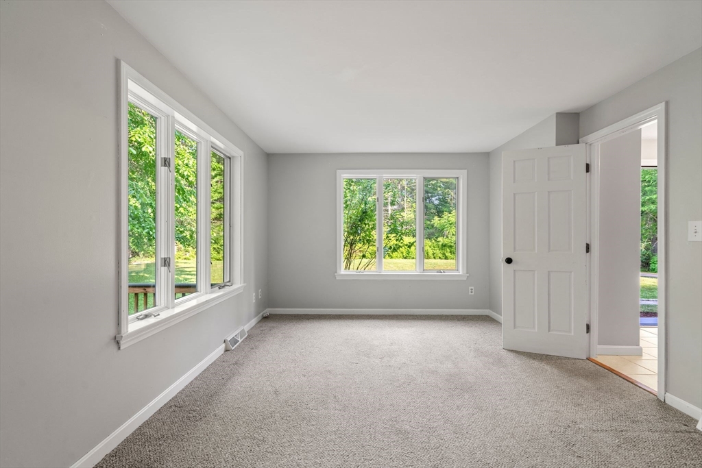 731 R Grove Street Norwell, MA 02061 - Photo 16 of 42 a view of a big room with windows and chandelier fan