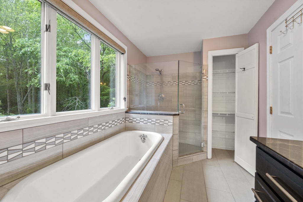 731 R Grove Street Norwell, MA 02061 - Photo 23 of 42 a bathroom with a tub a sink and a large window