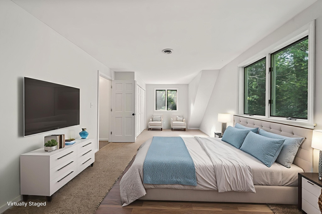 731 R Grove Street Norwell, MA 02061 - Photo 26 of 42 a bedroom with a bed and a flat screen tv