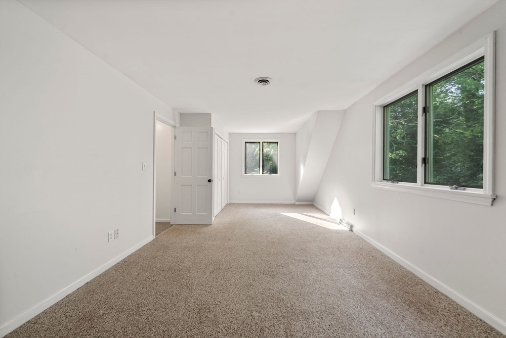 731 R Grove Street Norwell, MA 02061 - Photo 27 of 42 a view of a big room with windows and chandelier fan
