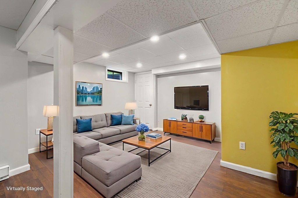 731 R Grove Street Norwell, MA 02061 - Photo 28 of 42 a living room with furniture and a flat screen tv