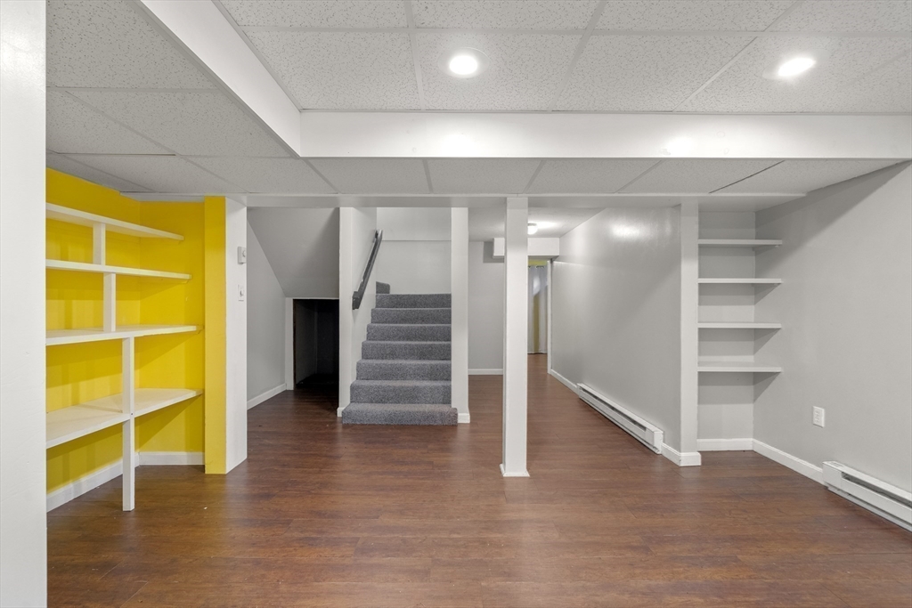 731 R Grove Street Norwell, MA 02061 - Photo 30 of 42 a view of an empty room with wooden floor and stairs