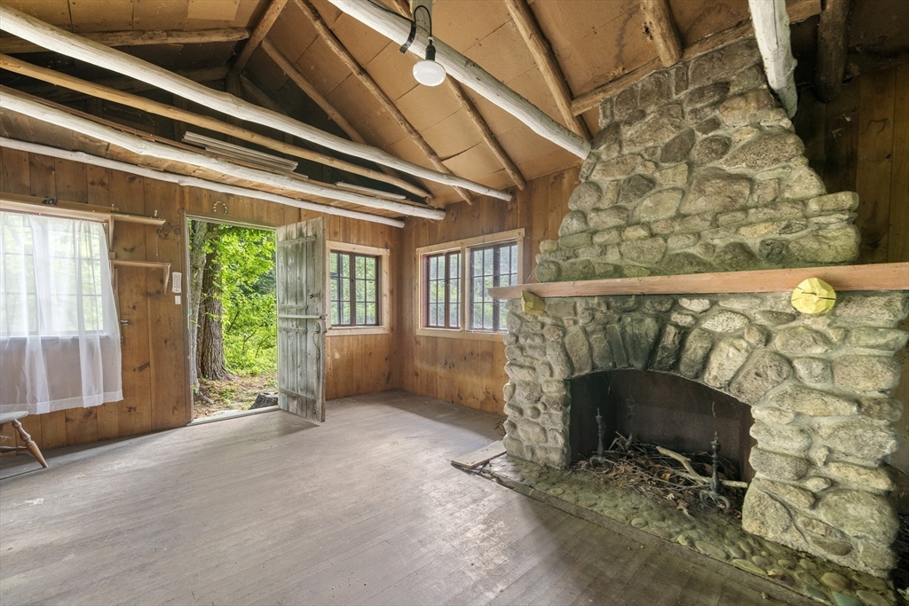 731 R Grove Street Norwell, MA 02061 - Photo 41 of 42 a living room with a fireplace and a floor to ceiling window