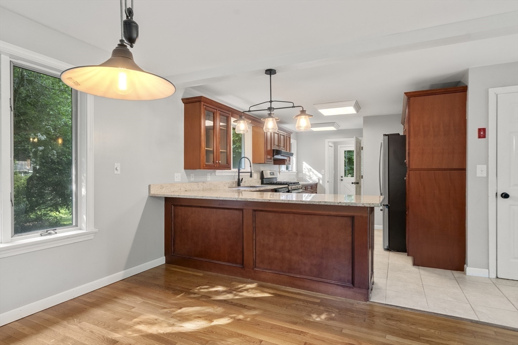731 R Grove Street Norwell, MA 02061 - Photo 7 of 42 a bathroom with a sink a refrigerator and a window