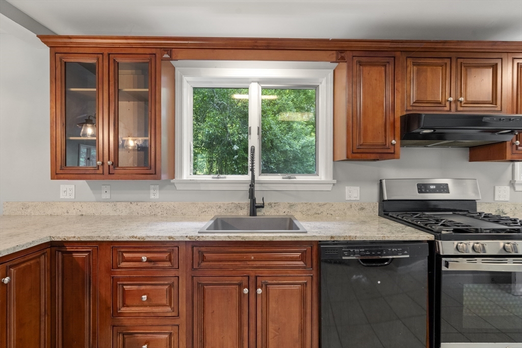731 R Grove Street Norwell, MA 02061 - Photo 9 of 42 a kitchen with granite countertop a stove sink and cabinets