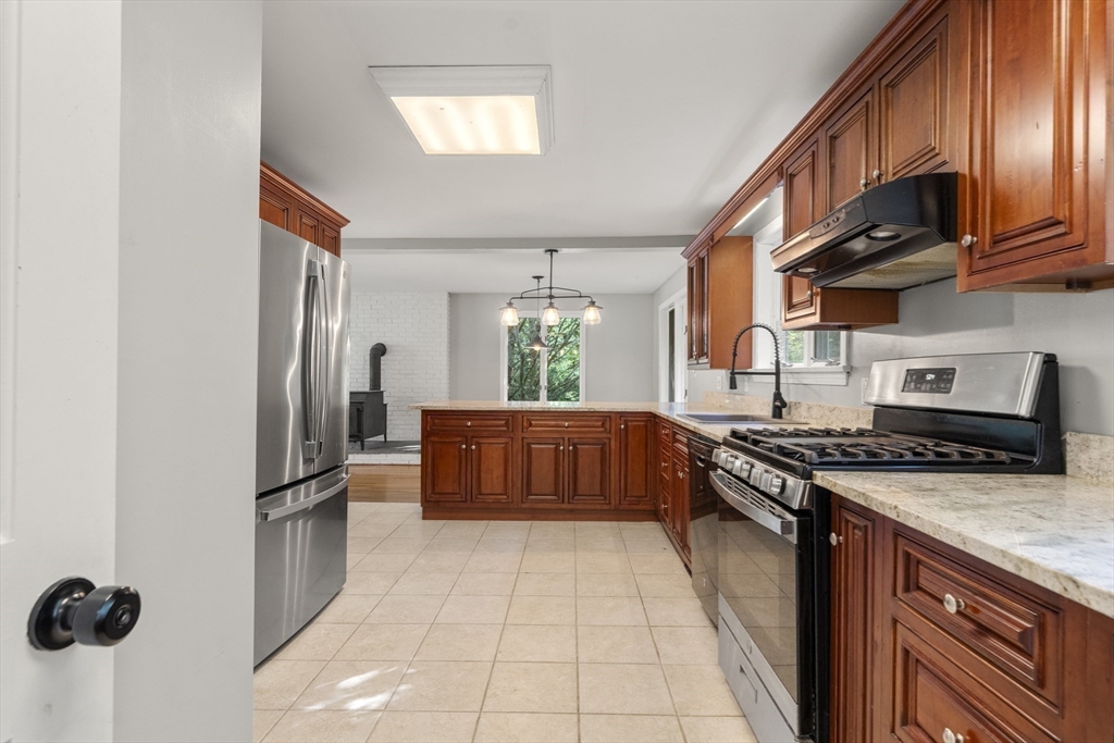 731 R Grove Street Norwell, MA 02061 - Photo 10 of 42 a kitchen with stainless steel appliances granite countertop a stove a refrigerator and a cabinets