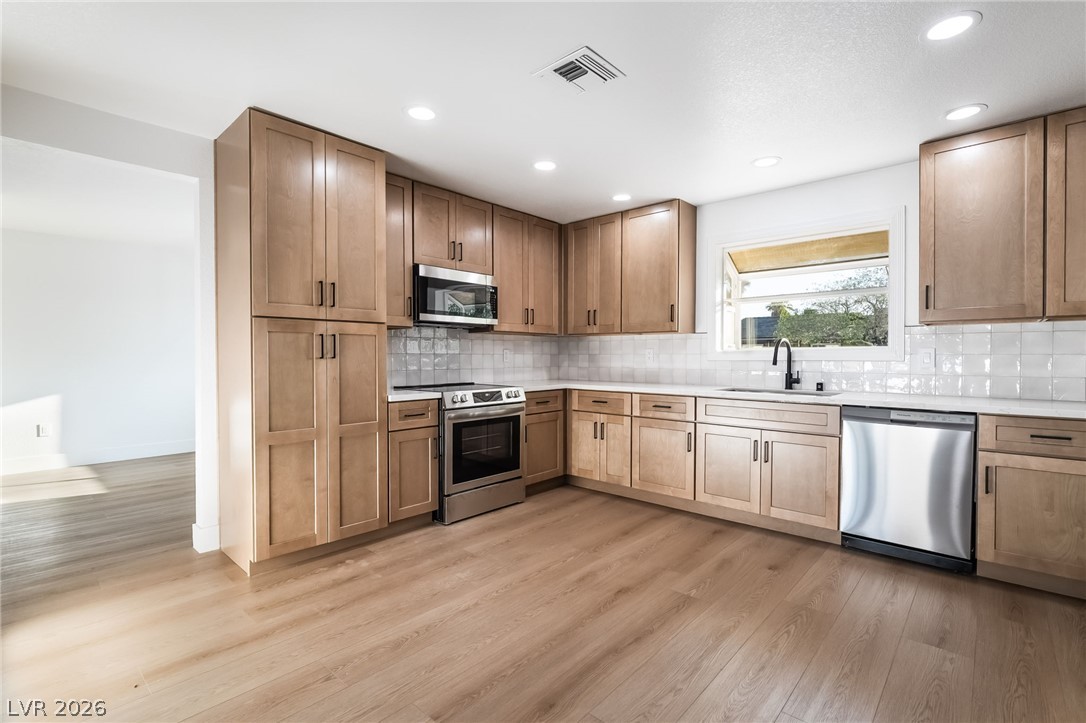 429 Crestway Road Henderson, NV 89015 - Photo 17 of 56 A contemporary culinary space showcasing sleek cabinetry and abundant task lighting.
