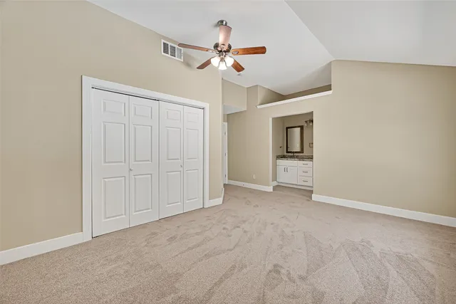 a view of an empty room with a ceiling fan
