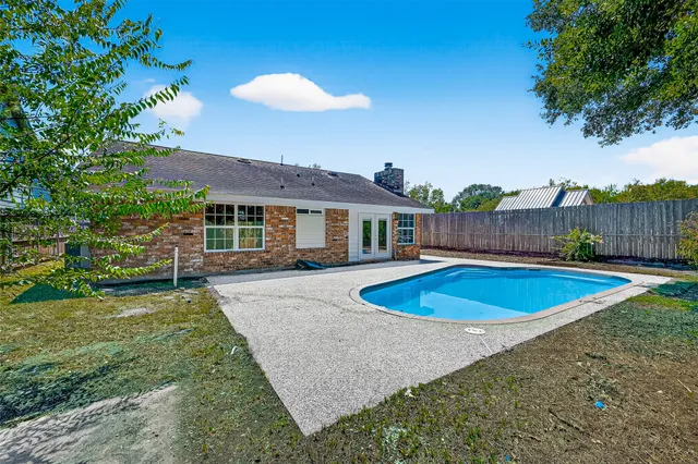 a view of a swimming pool with a patio