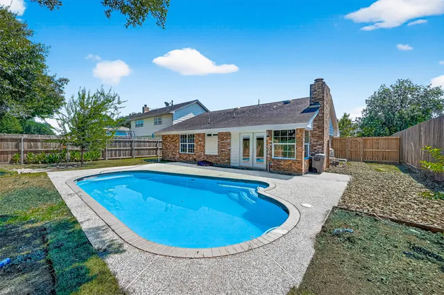 a view of a house with swimming pool and yard
