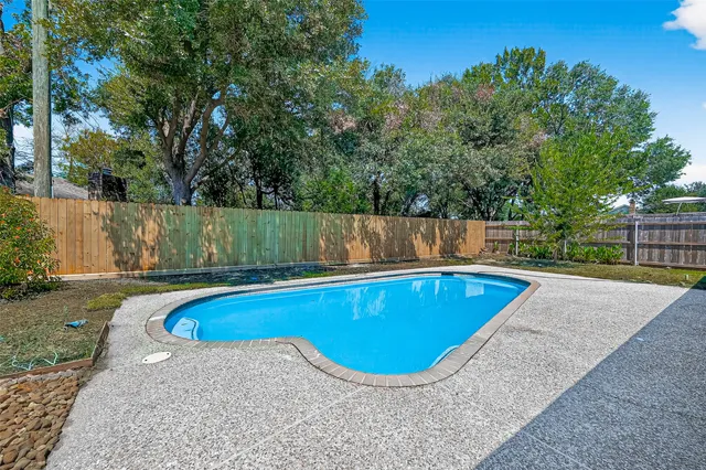 a view of a swimming pool and a yard