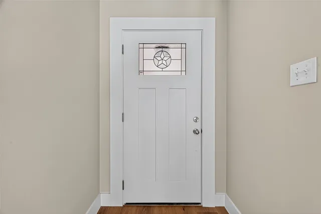 a view of hallway with wooden floor