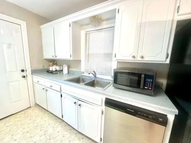 a kitchen with stainless steel appliances a refrigerator sink and cabinets