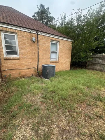 a backyard of a house with table and chairs