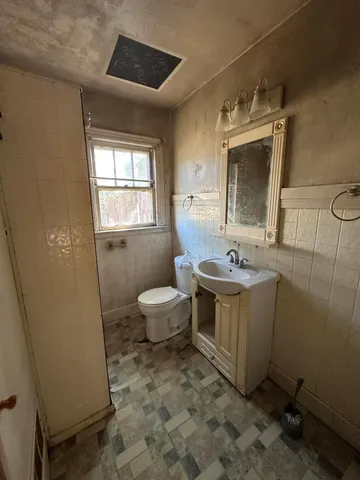 a kitchen with a sink window and cabinets