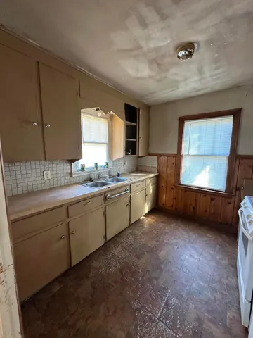 a white stove top oven sitting inside of a kitchen