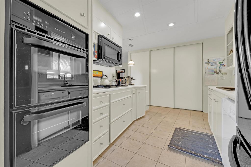 1010 Palm Canyon Drive, Unit 151 Borrego Springs, CA 92004 - Photo 16 of 31 a kitchen with stainless steel appliances kitchen island granite countertop a refrigerator and a stove top oven