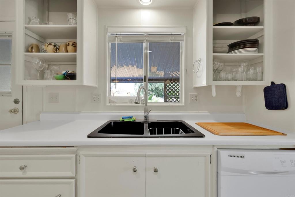 1010 Palm Canyon Drive, Unit 151 Borrego Springs, CA 92004 - Photo 17 of 31 a kitchen with a sink a stove and a window