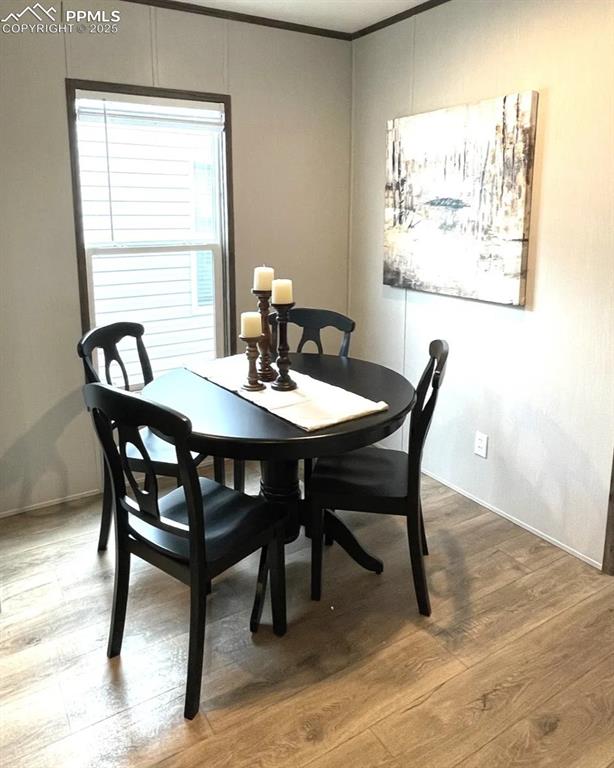 7490 Red Creek Springs Road Pueblo, CO 81005 - Photo 12 of 37 a view of a dining room with furniture and wooden floor