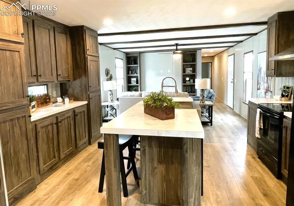 7490 Red Creek Springs Road Pueblo, CO 81005 - Photo 13 of 37 a dining hall with stainless steel appliances a table and chairs