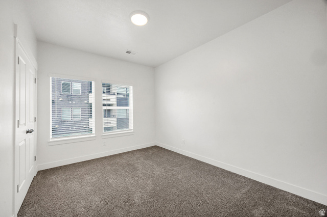 3115 South 200 West, Unit C201 Nibley, UT 84321 - Photo 11 of 23 Room featuring plush gray carpet, white walls, and a white ceiling with a flush-mount circular light fixture