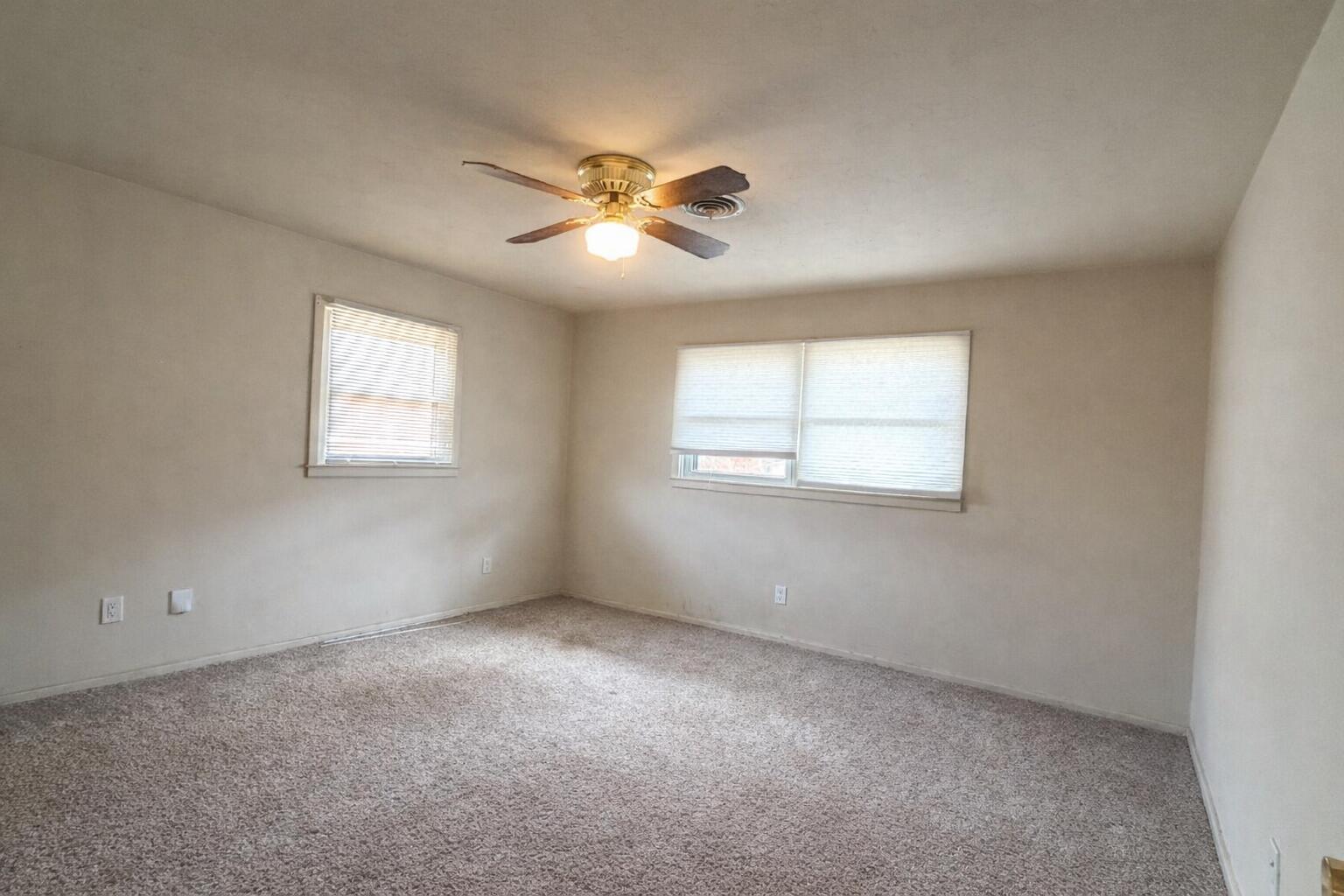 3414 57th Street Lubbock, TX 79413 - Photo 12 of 17 a view of an empty room with a window