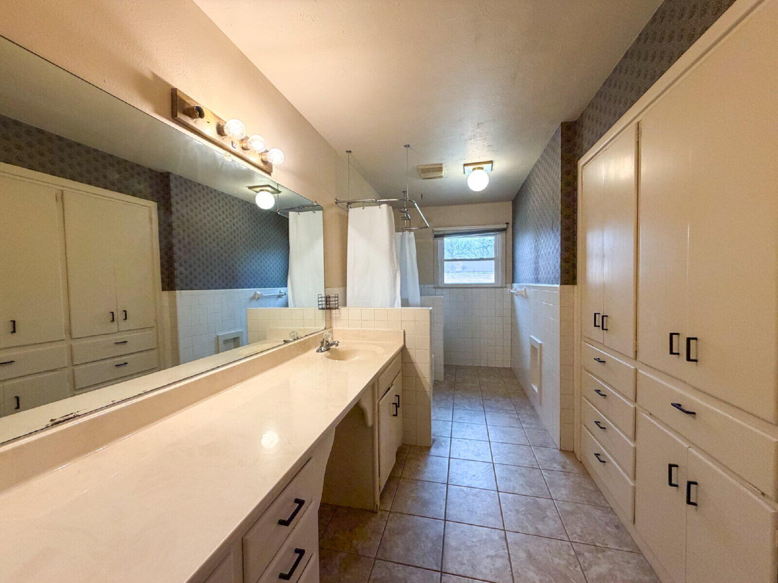 3414 57th Street Lubbock, TX 79413 - Photo 13 of 17 a large bathroom with a large tub and sink