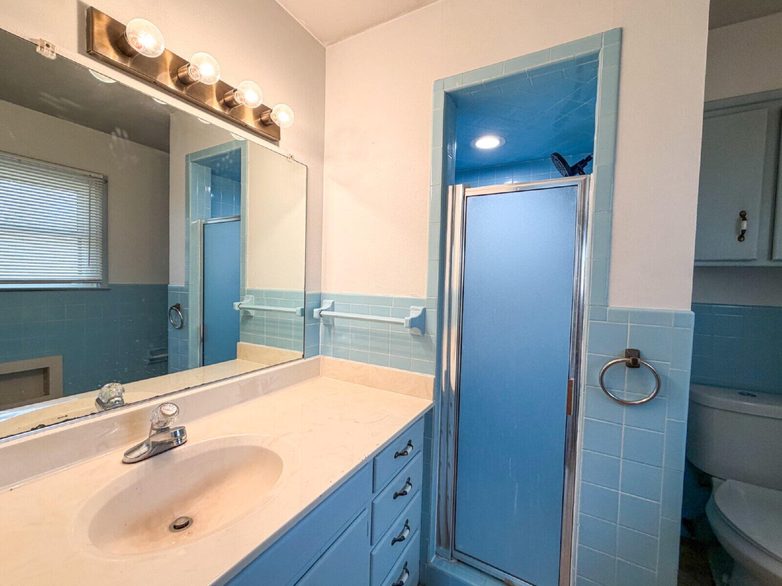 3414 57th Street Lubbock, TX 79413 - Photo 15 of 17 a bathroom with a sink and a mirror