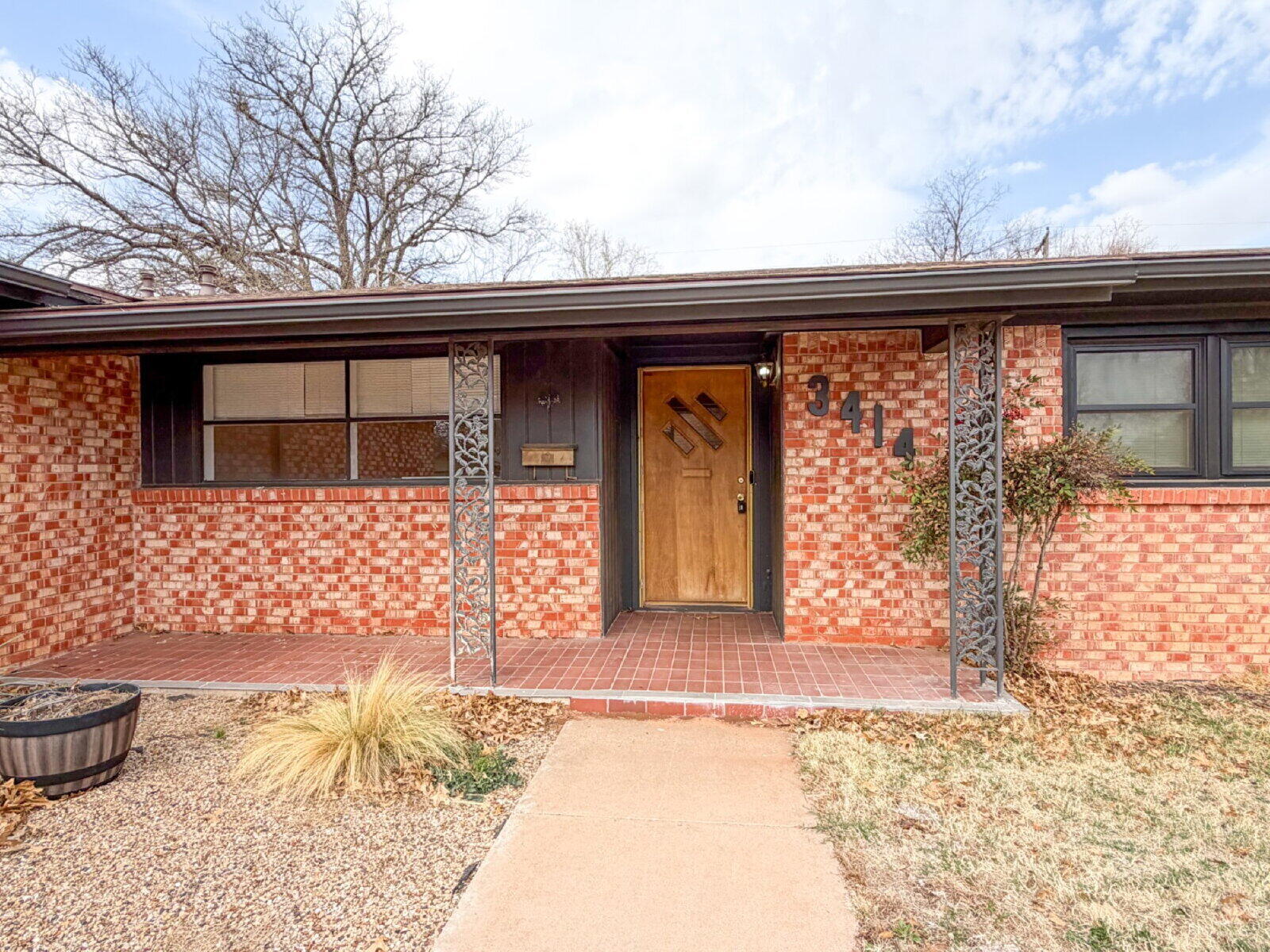 3414 57th Street Lubbock, TX 79413 - Photo 2 of 17 a front view of a house with a outdoor space