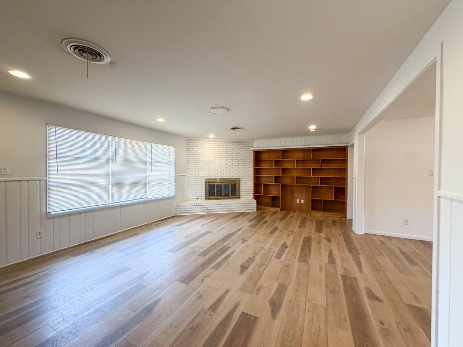 3414 57th Street Lubbock, TX 79413 - Photo 5 of 17 a view of empty room with wooden floor and window