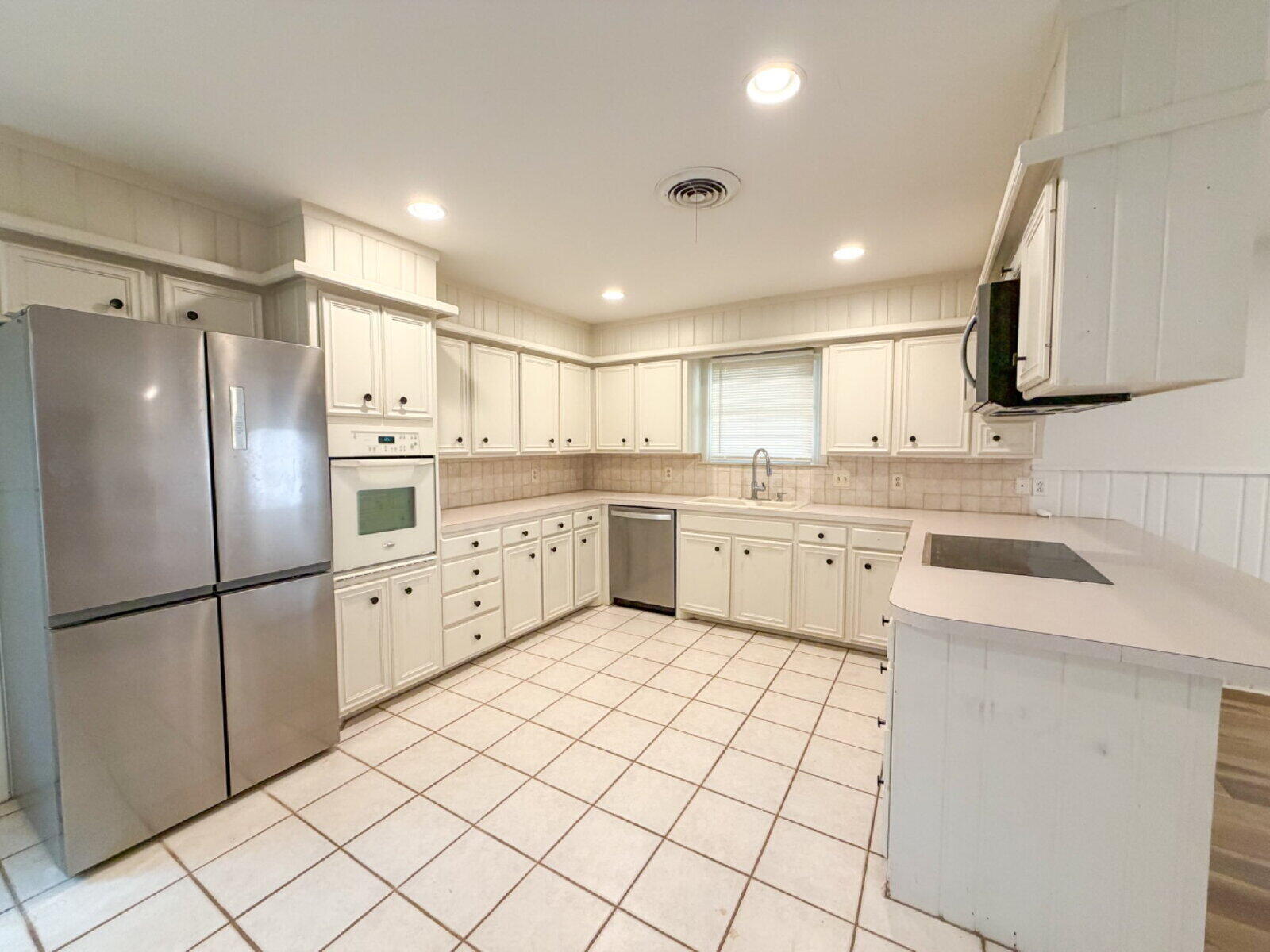 3414 57th Street Lubbock, TX 79413 - Photo 8 of 17 a kitchen with white cabinets stainless steel appliances and sink