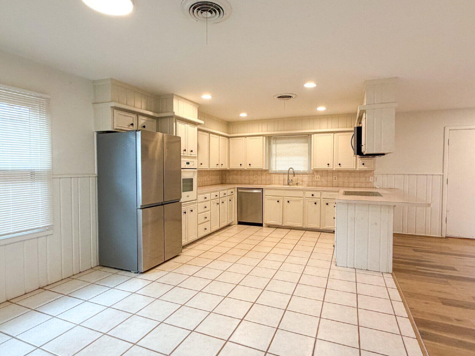 3414 57th Street Lubbock, TX 79413 - Photo 9 of 17 a kitchen with a refrigerator sink and cabinets