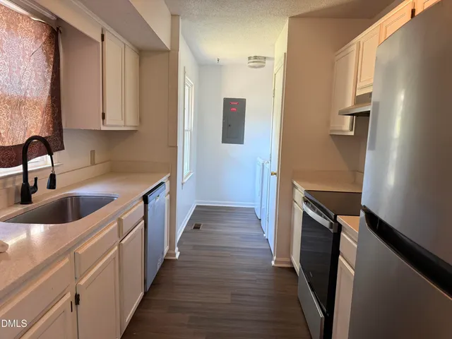 a kitchen with a sink and refrigerator