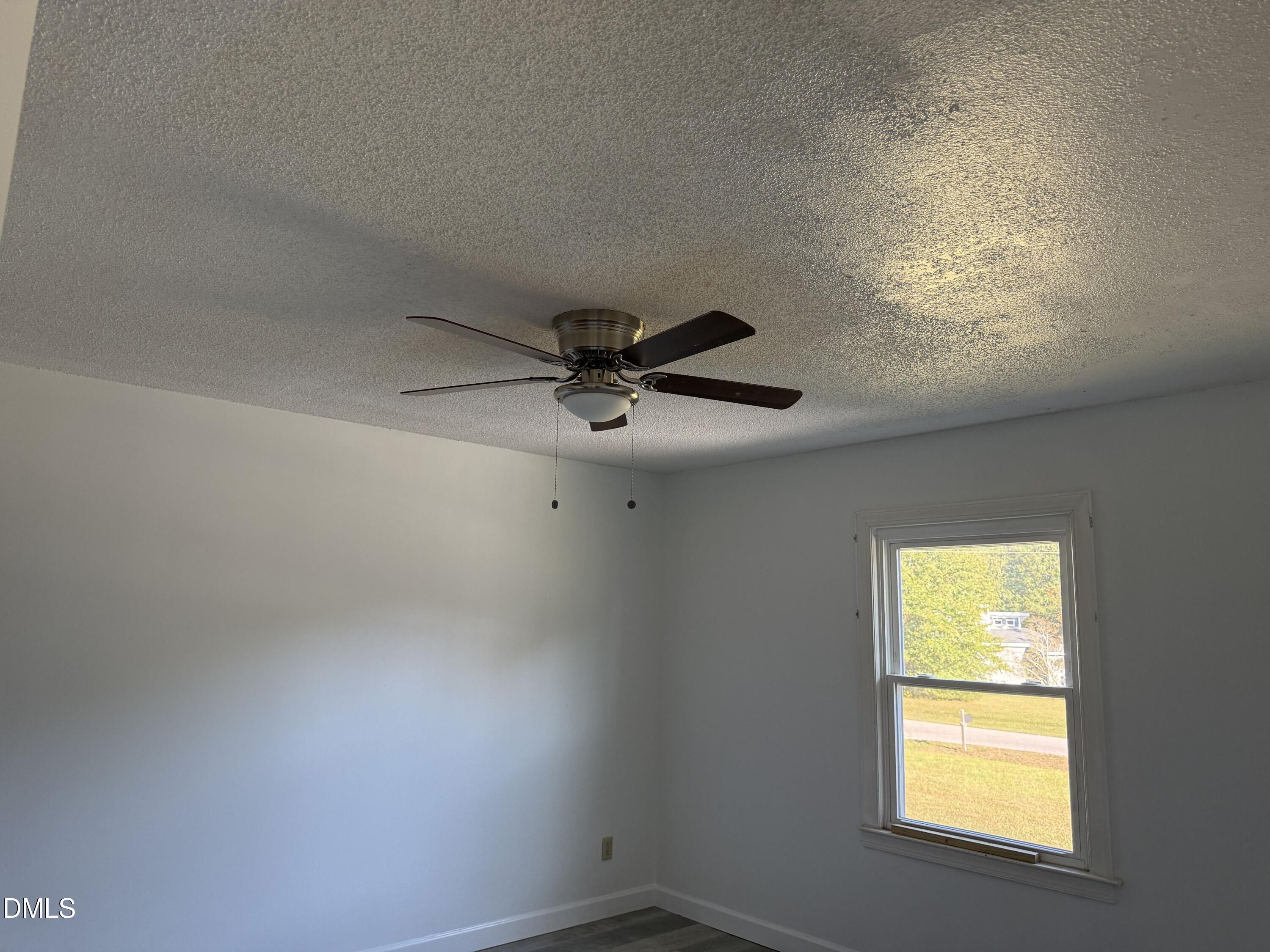 5509 Sandy Run Knightdale, NC 27545 - Photo 14 of 21 an empty room with a window and a fan